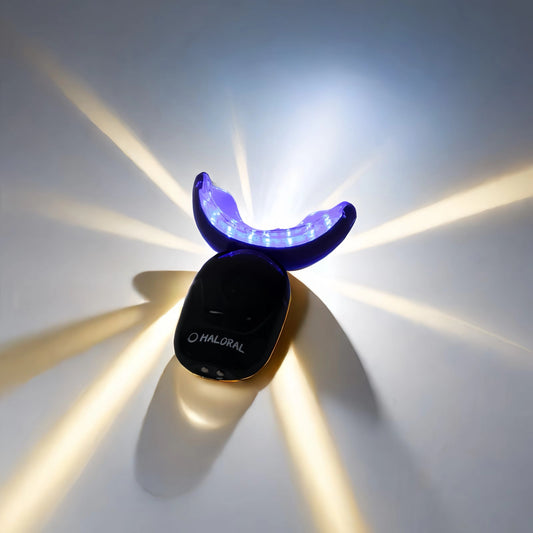 Haloral Halo Pro LED Wireless Teeth Whitening Kit glowing with dual-light technology for a brighter smile.