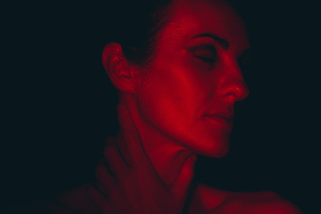 Woman receiving red light therapy for skin rejuvenation and relaxation, showcasing the therapeutic benefits of red light for a radiant, youthful appearance.