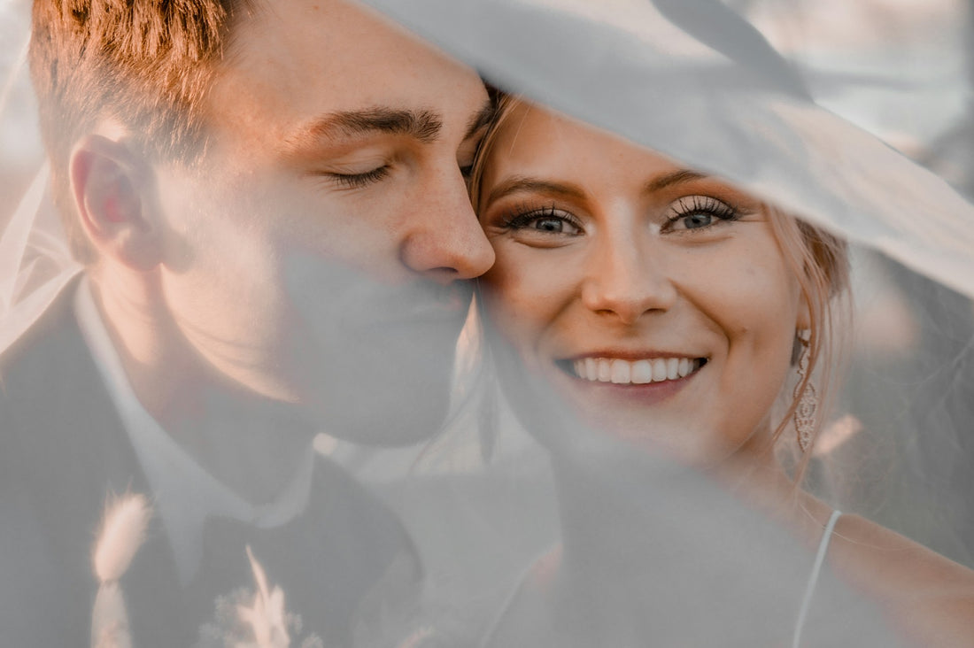 A happy bride and groom sharing a moment, with the bride’s radiant smile taking center stage.