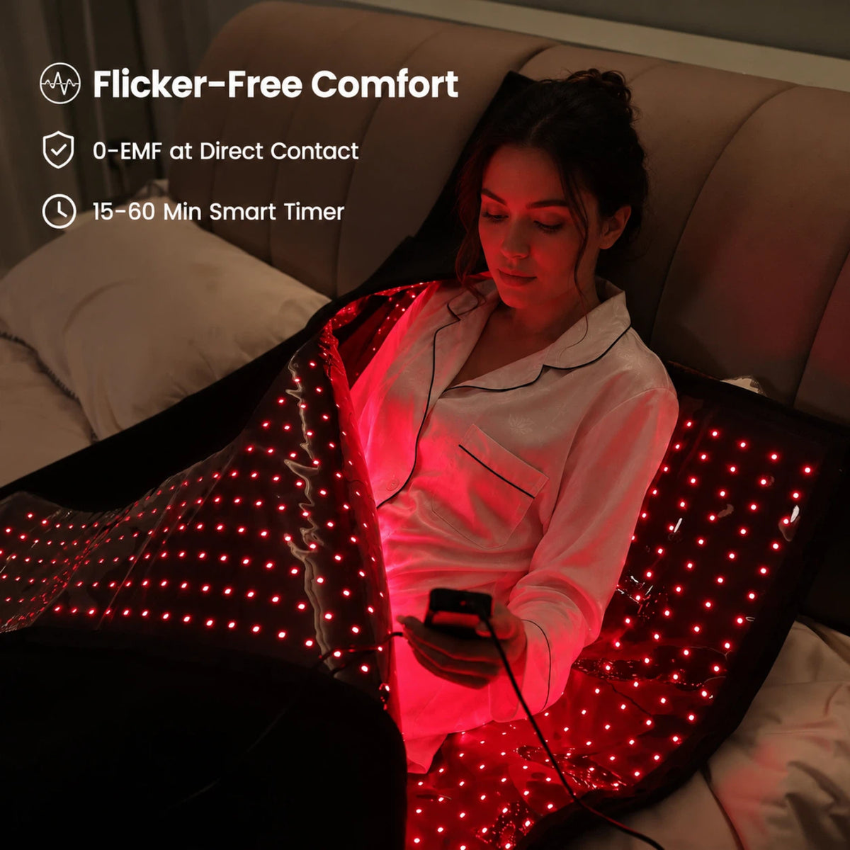 Woman using the Haloral Red and Infrared Light Therapy Bag in bed with flicker-free comfort, 0-EMF direct contact design and 15–60 minute smart timer.
