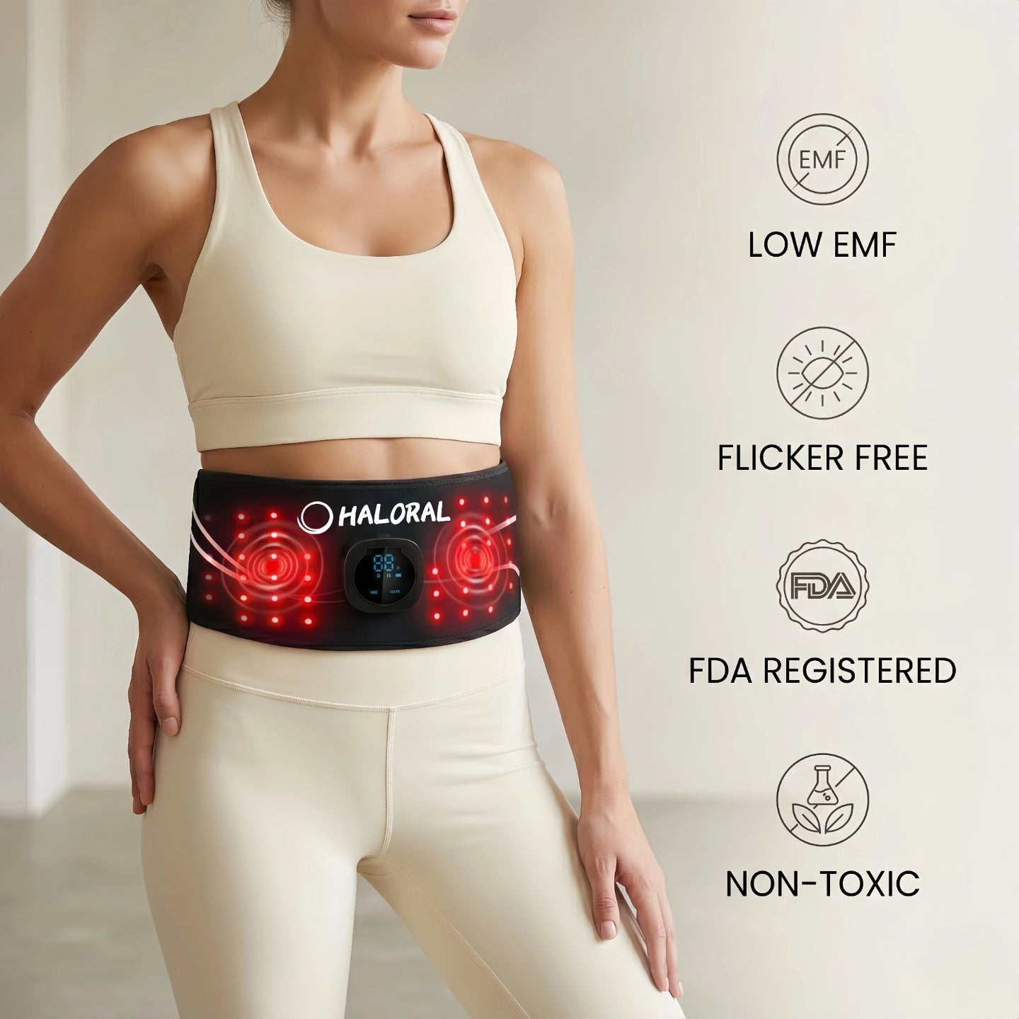 Woman wearing Haloral red light therapy belt highlighting low EMF, flicker-free, FDA registered, and non-toxic safety features